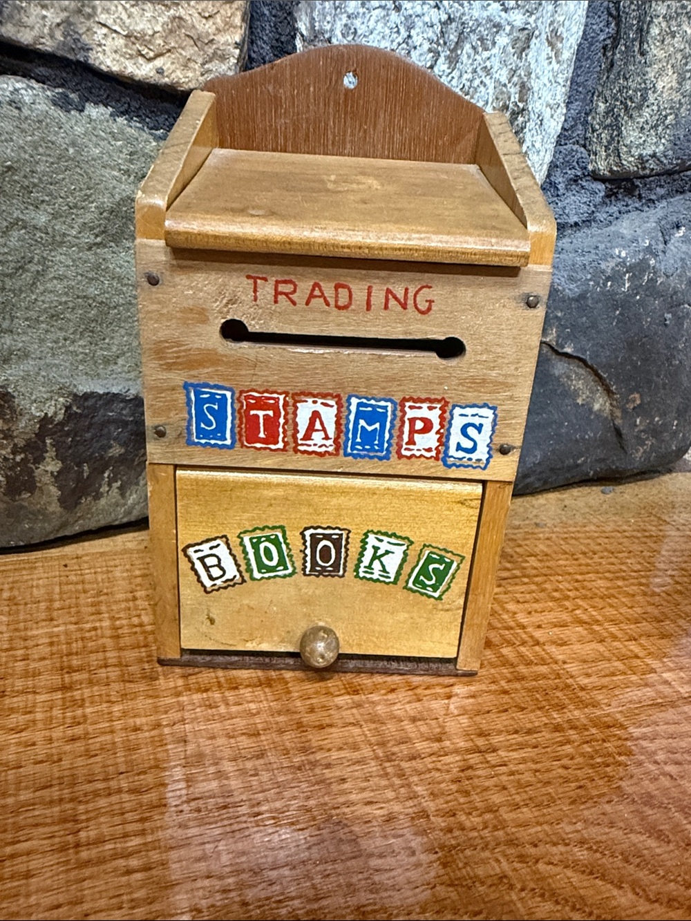 Wooden Green stamp holder with a few stamps.